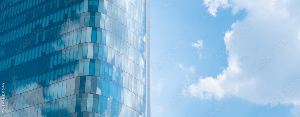 A glass tower reflecting cloud